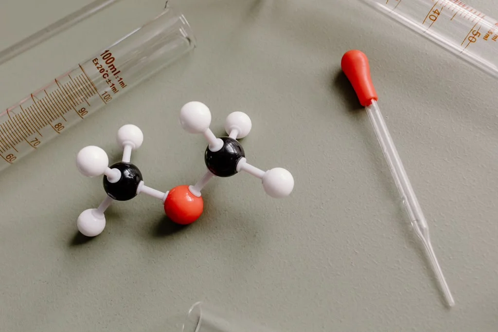 Molecular model and laboratory glassware representing peptide therapy